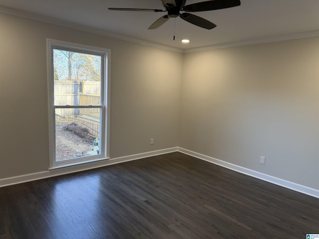 empty room with crown molding, visible vents, dark wood finished floors, and baseboards