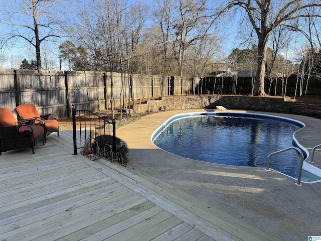 view of pool with a fenced in pool, a fenced backyard, and a wooden deck