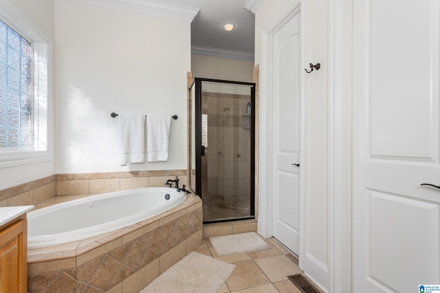 bathroom with a shower stall, vanity, ornamental molding, and tile patterned floors