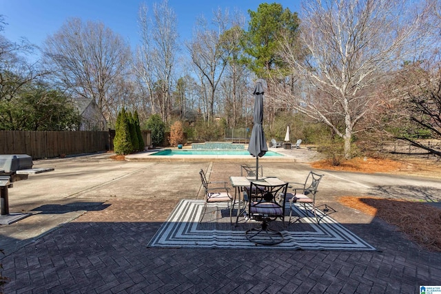 view of patio featuring fence and a fenced in pool