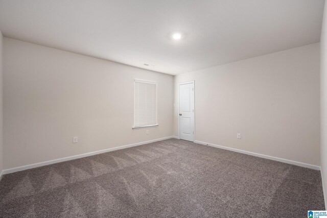 empty room featuring carpet floors and baseboards