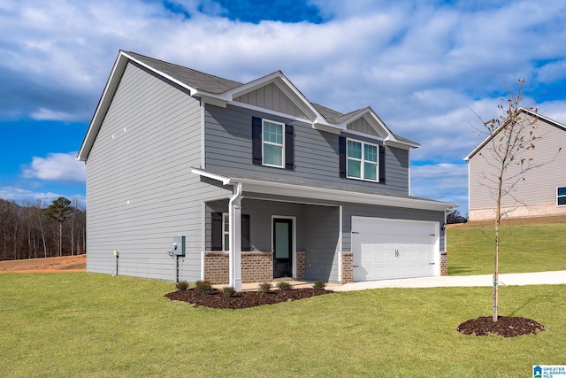 craftsman-style home featuring board and batten siding, a front yard, concrete driveway, and an attached garage