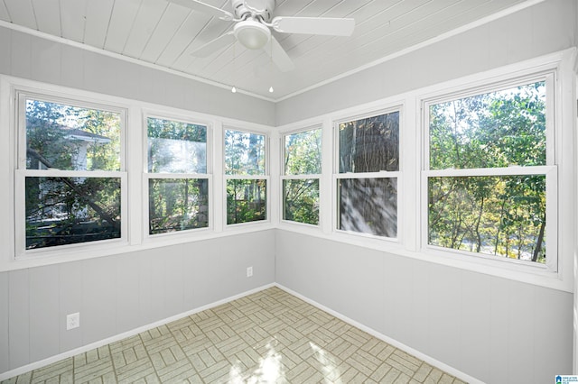 unfurnished sunroom with a ceiling fan