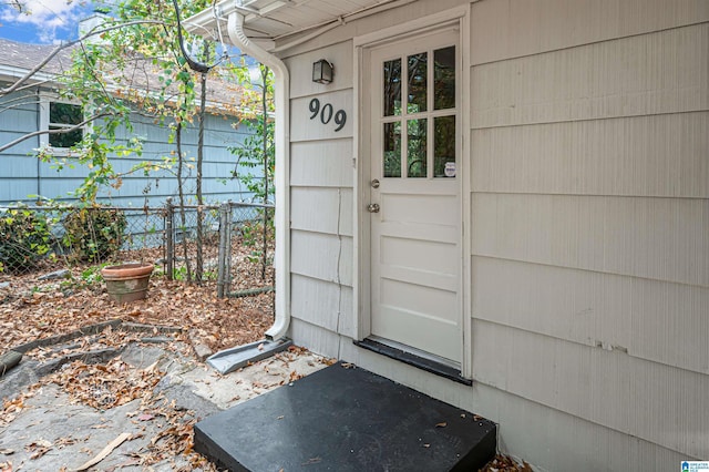 doorway to property featuring fence