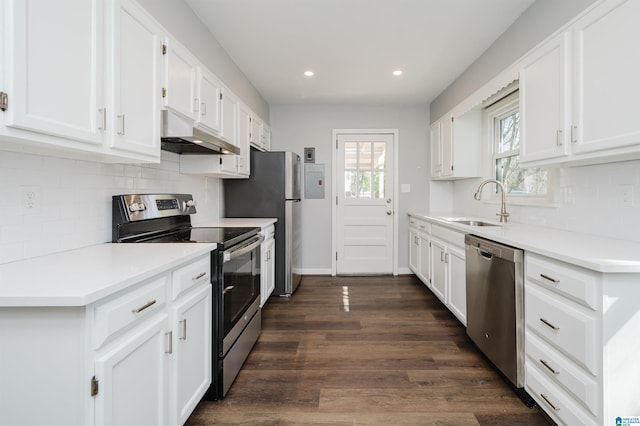 kitchen featuring stainless steel appliances, light countertops, under cabinet range hood, and white cabinetry