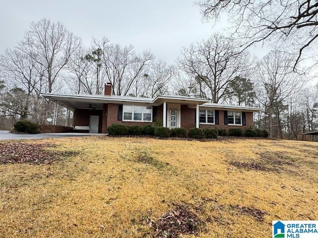 ranch-style house with an attached carport, brick siding, and a front yard