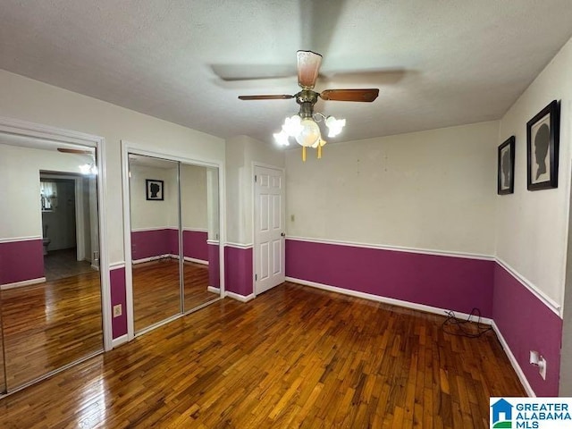 unfurnished bedroom with a ceiling fan, a closet, dark wood finished floors, and baseboards