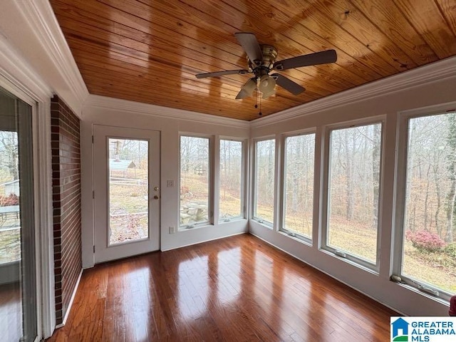 unfurnished sunroom featuring wooden ceiling and a ceiling fan