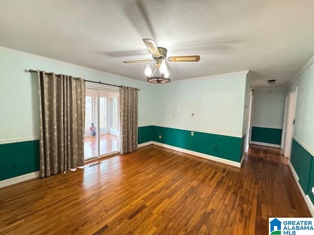 unfurnished room featuring visible vents, ceiling fan, wood finished floors, crown molding, and a textured ceiling