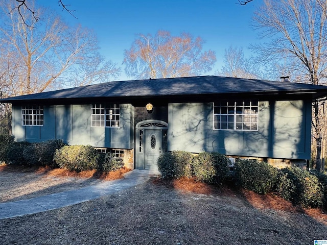 split foyer home with driveway and a shingled roof