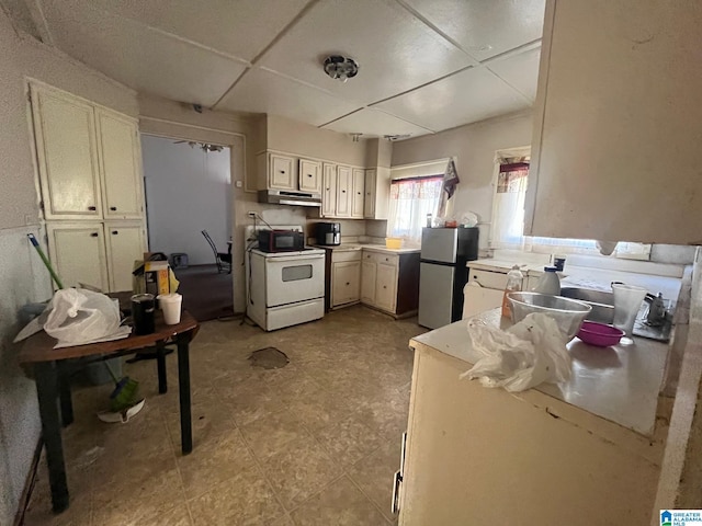 kitchen with white range with electric cooktop, light countertops, freestanding refrigerator, white cabinetry, and under cabinet range hood