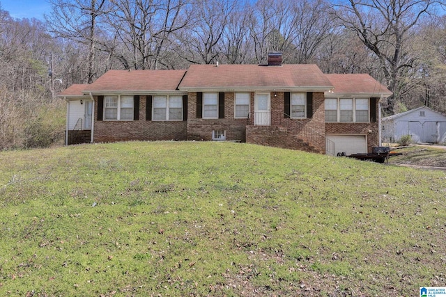 ranch-style home with brick siding, a garage, a chimney, and a front lawn