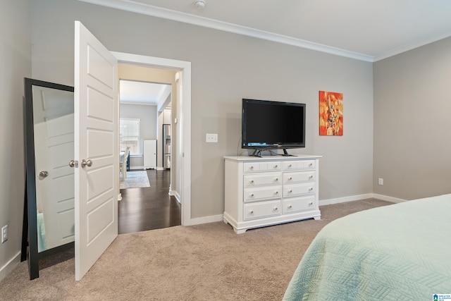 bedroom with ornamental molding, carpet flooring, and baseboards