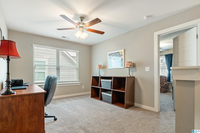 carpeted office space with visible vents, ceiling fan, and baseboards