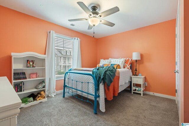 bedroom featuring a ceiling fan, visible vents, baseboards, and carpet flooring