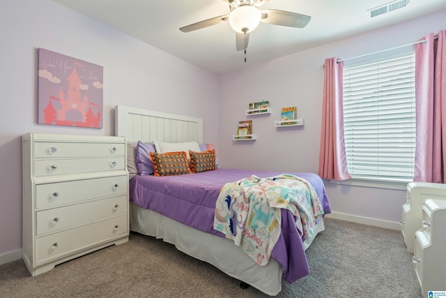 carpeted bedroom featuring baseboards, multiple windows, and visible vents