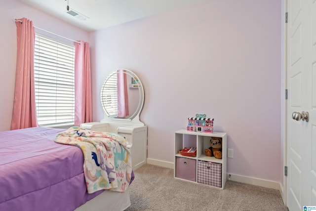 carpeted bedroom featuring baseboards, multiple windows, and visible vents