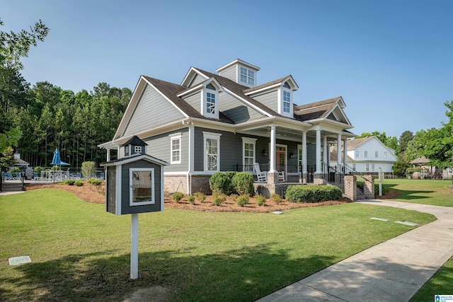 view of front of house with a porch and a front lawn