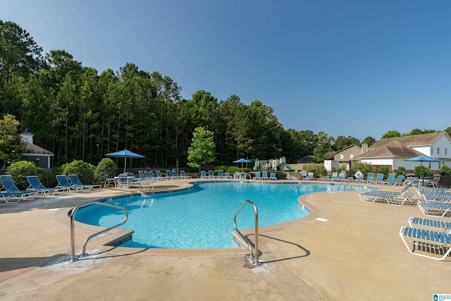 pool featuring a patio and fence