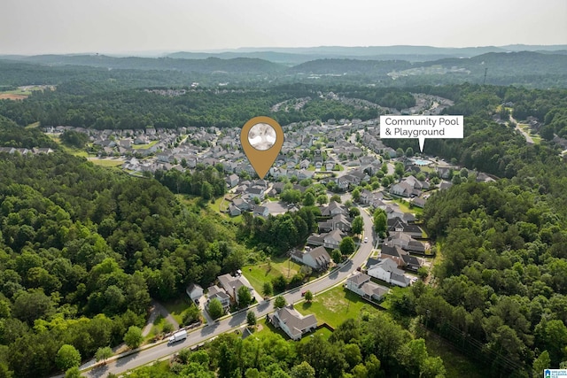 drone / aerial view with a residential view and a view of trees