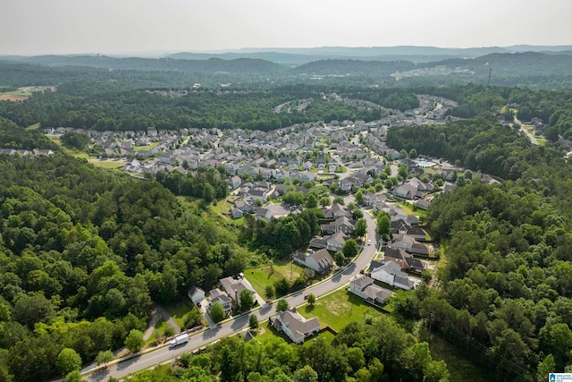 drone / aerial view with a forest view and a residential view