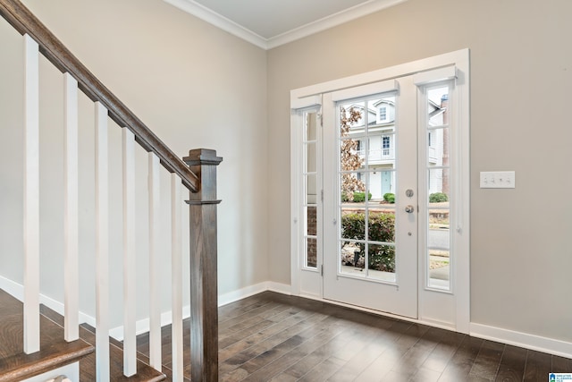 foyer entrance featuring dark wood-style floors, crown molding, baseboards, and stairs