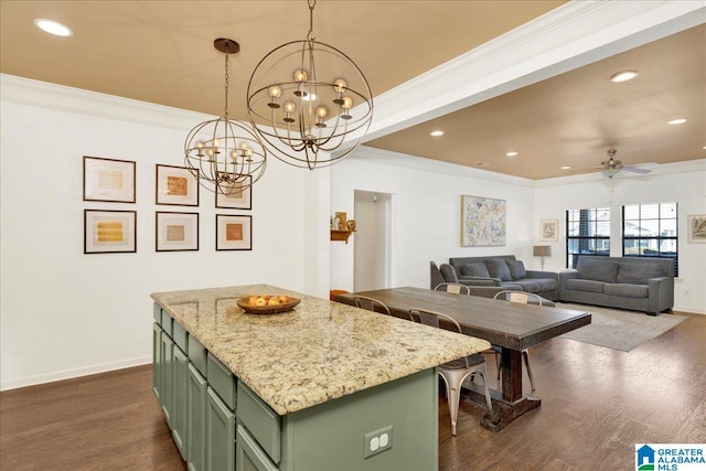 kitchen with ornamental molding, dark wood finished floors, and green cabinets