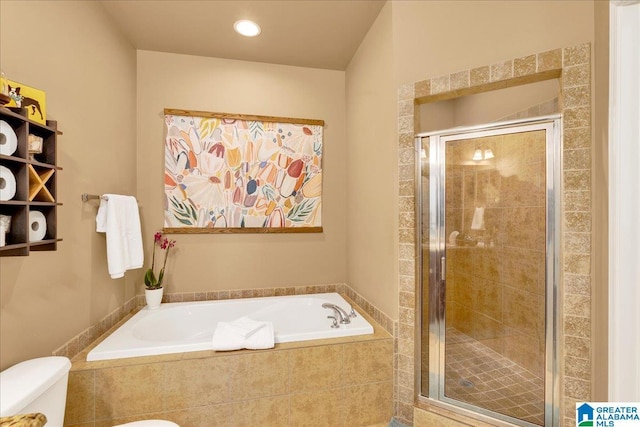 bathroom featuring a stall shower, a garden tub, and toilet