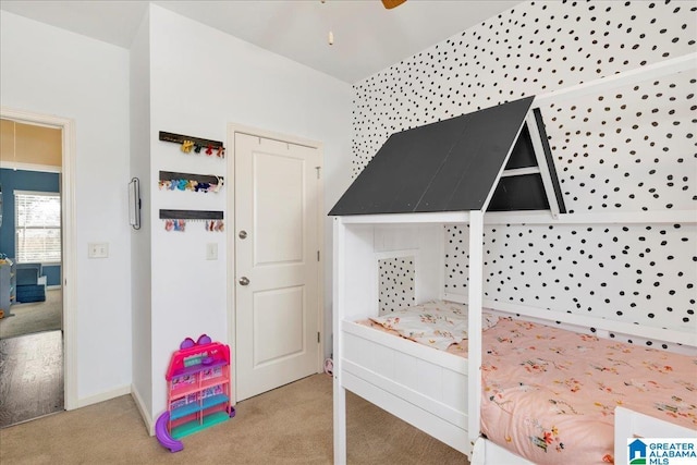 bedroom with carpet floors and baseboards