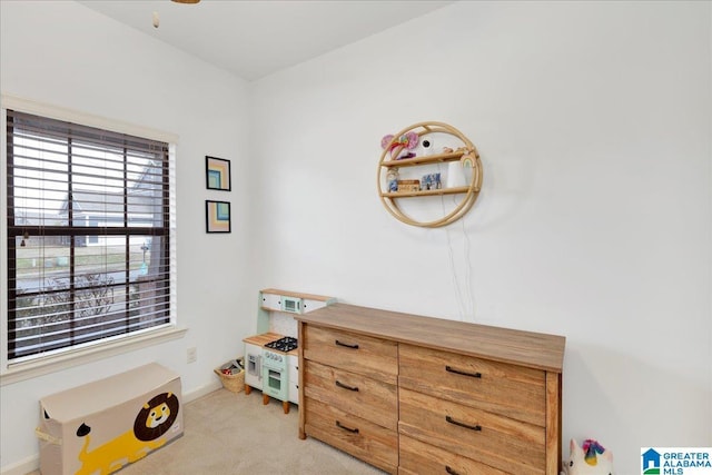 misc room with baseboards and light colored carpet