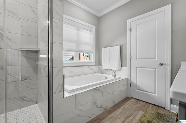 full bathroom with wood finished floors, a stall shower, a garden tub, and crown molding