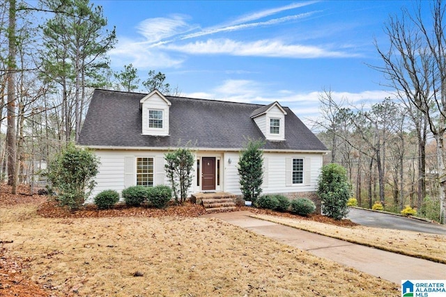 cape cod home with a shingled roof