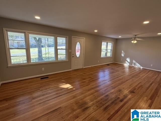 entrance foyer featuring baseboards, dark wood finished floors, visible vents, and recessed lighting