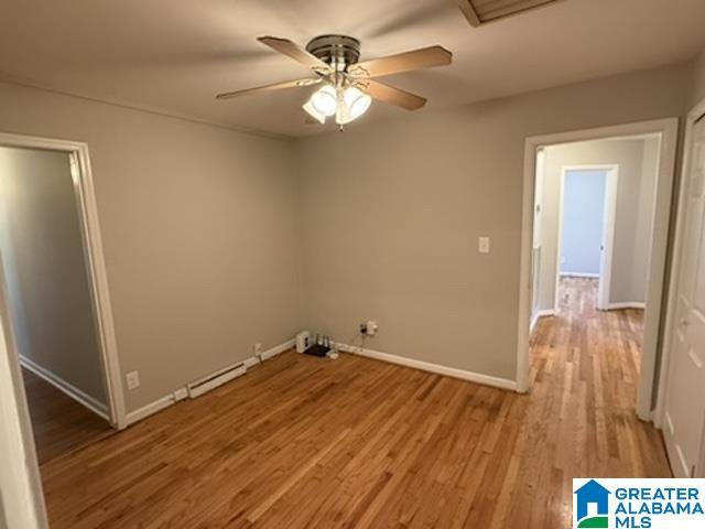 laundry room with light wood finished floors, ceiling fan, and baseboards