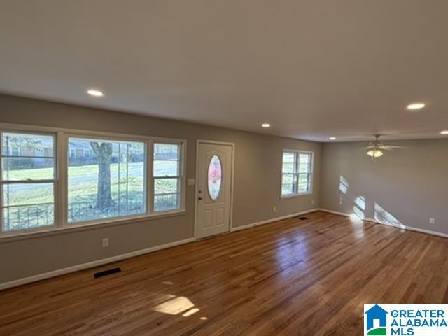 entrance foyer with baseboards, dark wood-type flooring, visible vents, and recessed lighting