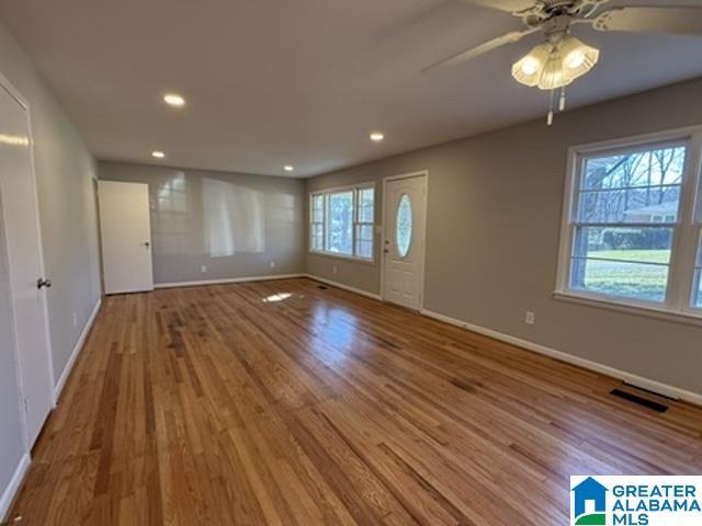 interior space with ceiling fan, recessed lighting, wood finished floors, visible vents, and baseboards