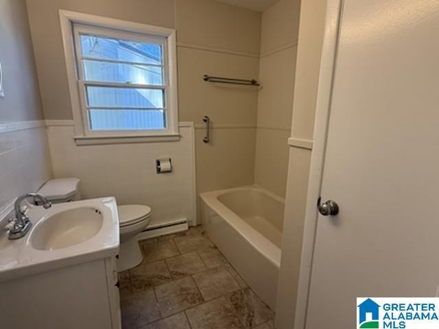 full bath with a baseboard radiator, vanity, and toilet