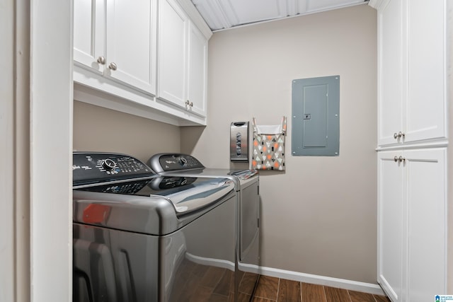 laundry area with dark wood-type flooring, washer and dryer, electric panel, and cabinet space