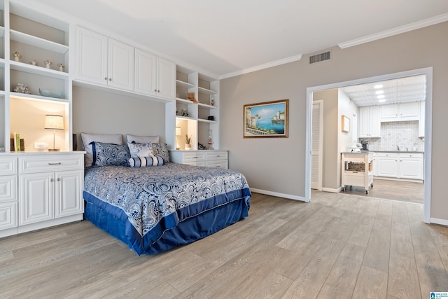 bedroom featuring light wood-type flooring, baseboards, visible vents, and crown molding