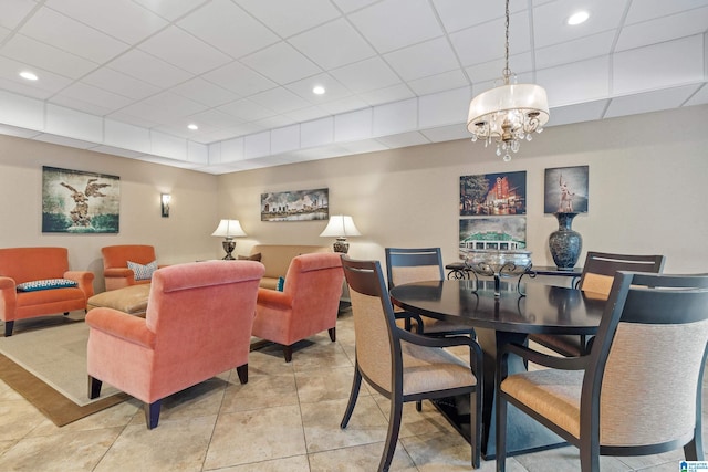 dining area featuring a chandelier, light tile patterned floors, a paneled ceiling, and recessed lighting