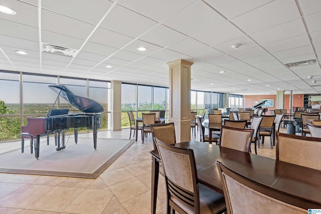 dining space featuring a wealth of natural light, visible vents, decorative columns, and light tile patterned floors