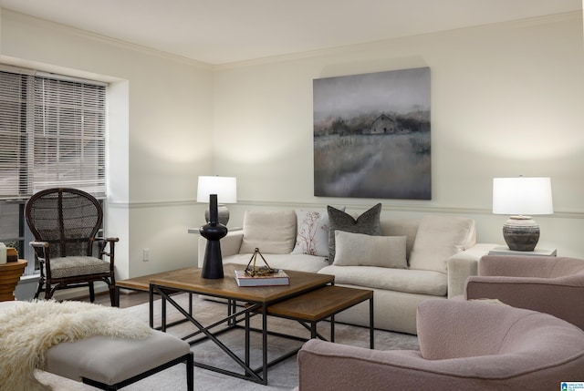 living area featuring ornamental molding and wood finished floors