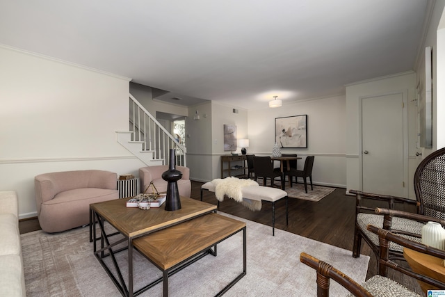 living area with stairs, baseboards, wood finished floors, and crown molding