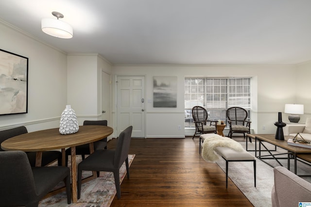 dining room featuring dark wood-style flooring and crown molding