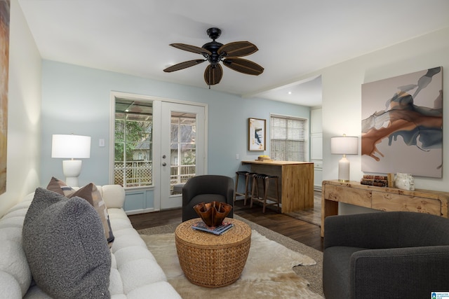 living room with french doors, ceiling fan, and dark wood-style flooring