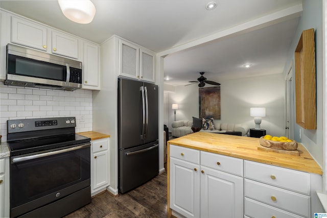 kitchen with tasteful backsplash, appliances with stainless steel finishes, wood counters, and white cabinets