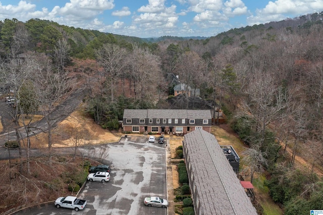 birds eye view of property with a wooded view