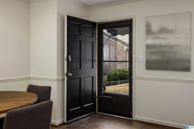 interior space with ornamental molding, baseboards, and dark wood-style floors