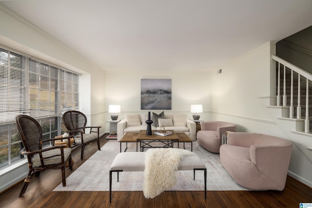 living room with baseboards, stairs, ornamental molding, and wood finished floors