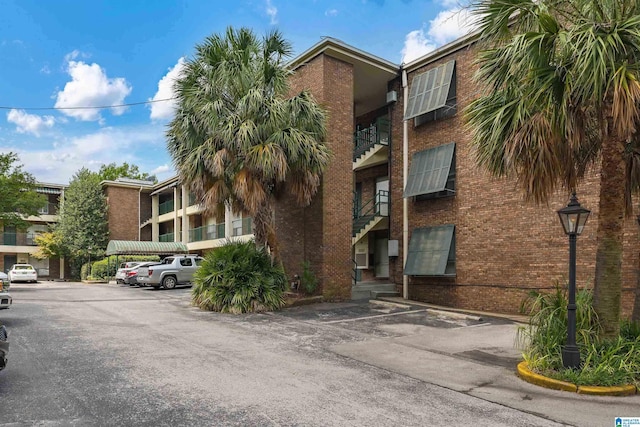 view of property featuring uncovered parking